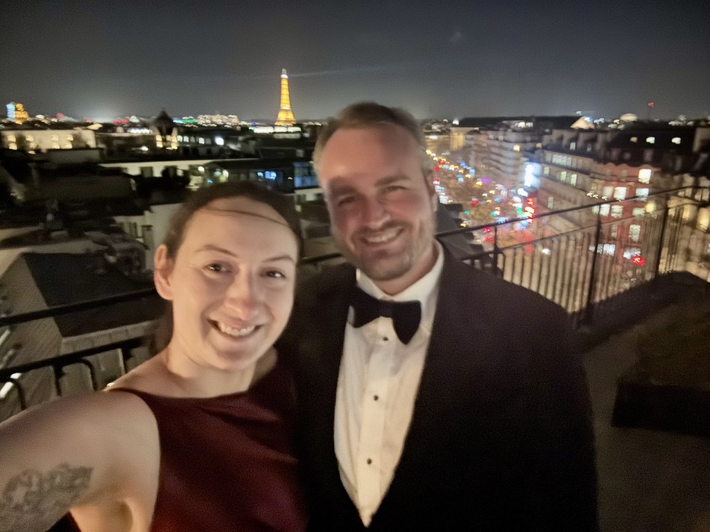 Sarah and Brady on a Paris rooftop with the Eiffel Tower